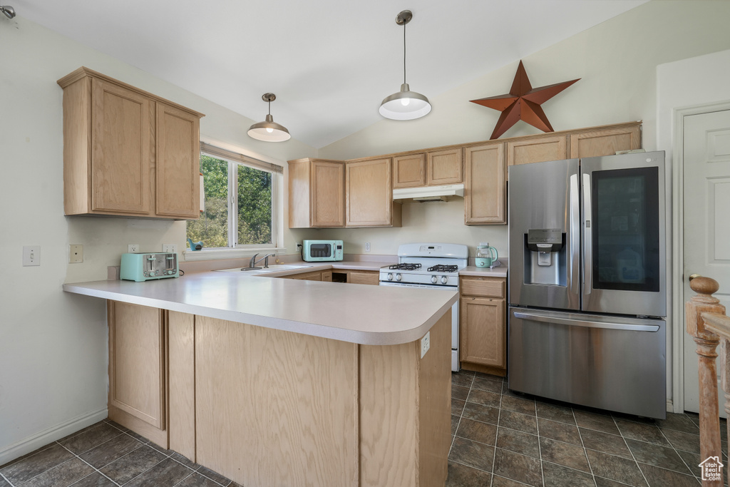 Kitchen featuring white appliances, a peninsula, lofted ceiling, light brown cabinets, and light countertops