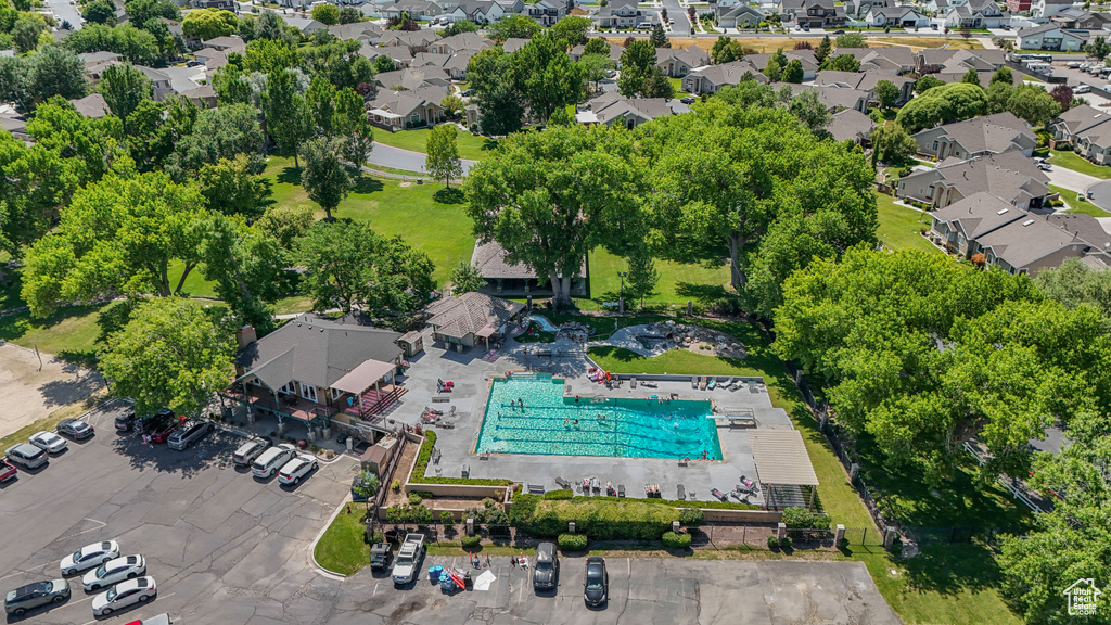 Aerial overview of property's location featuring a pool and nearby suburban area