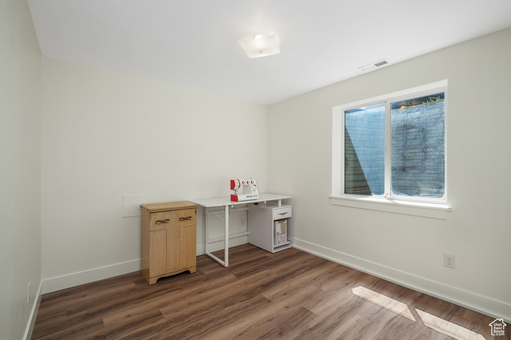 Home office with wood finished floors and baseboards