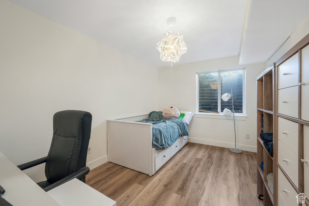 Bedroom featuring light wood-type flooring and baseboards
