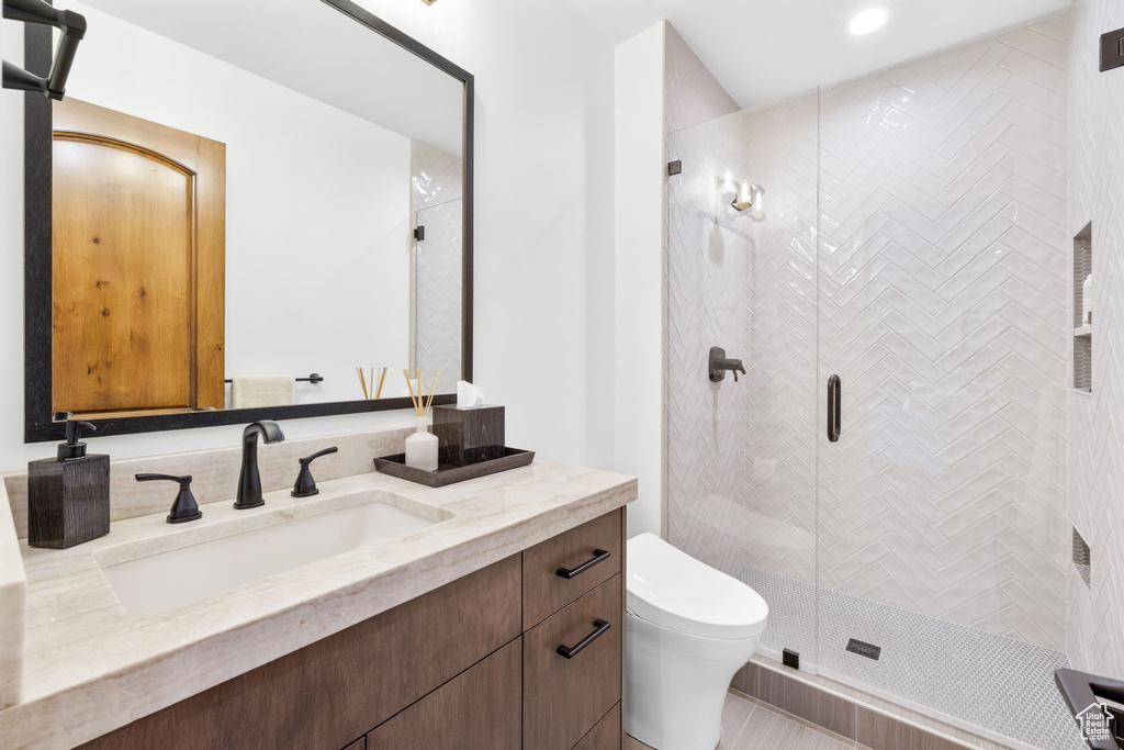 Full bath with vanity, a shower stall, and recessed lighting