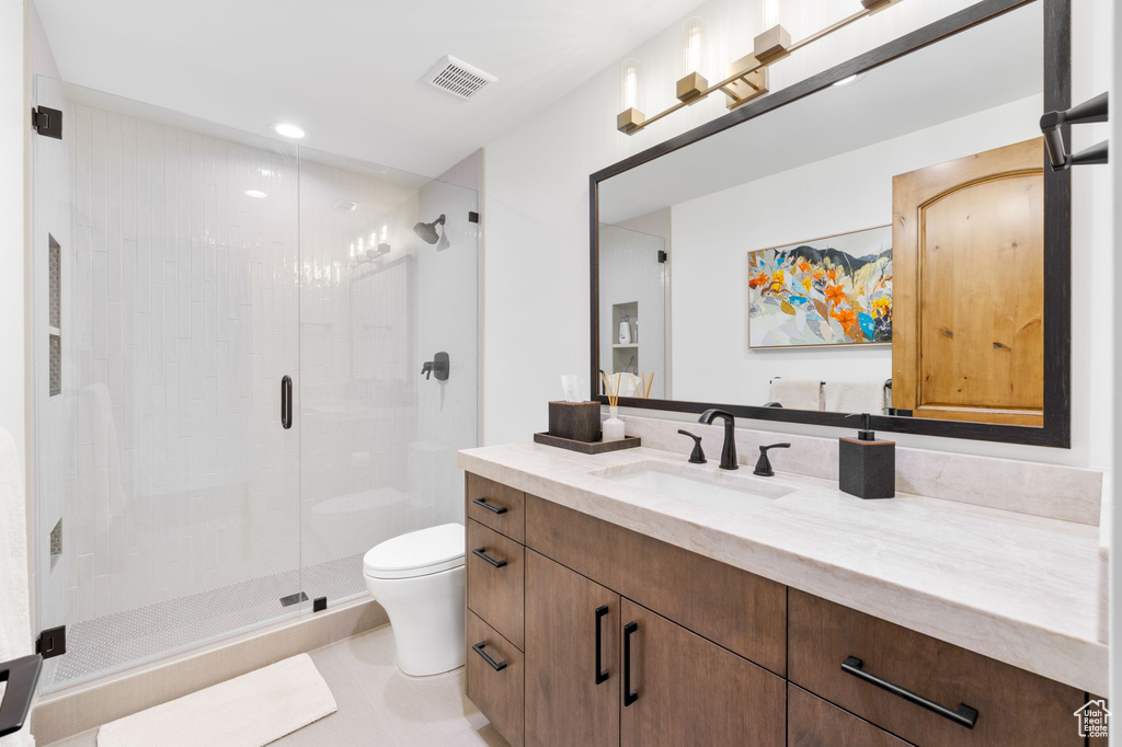 Full bathroom featuring a shower stall, vanity, and recessed lighting