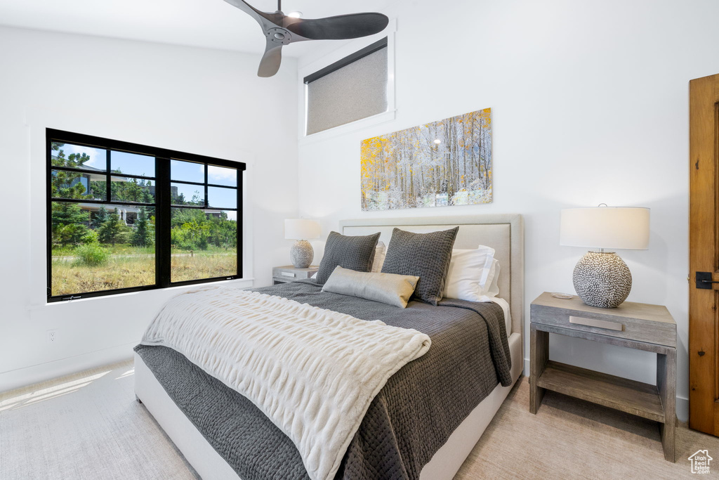 Carpeted bedroom with high vaulted ceiling and ceiling fan