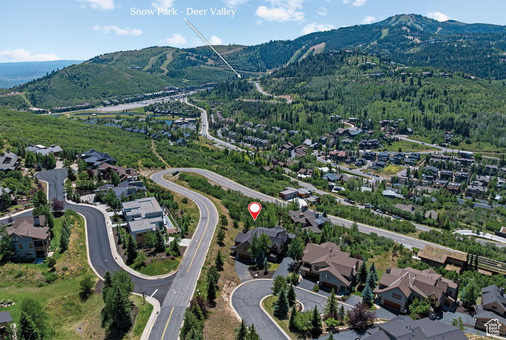 Aerial view of property and surrounding area featuring nearby suburban area