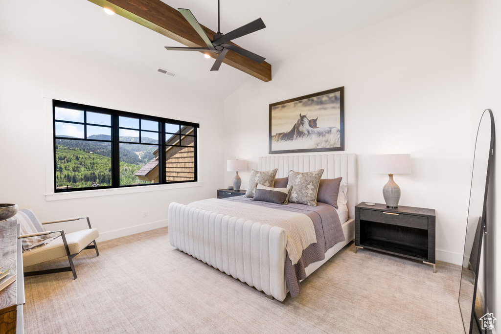 Bedroom with ceiling fan and light colored carpet