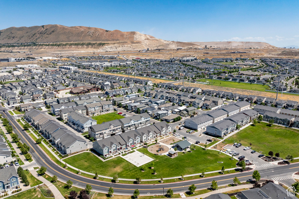 Aerial view of property and surrounding area with mountains and nearby suburban area