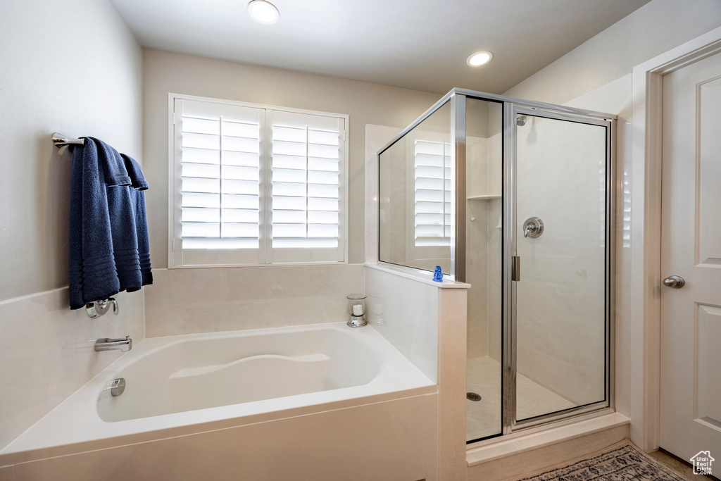 Full bathroom with a bath, a stall shower, and recessed lighting
