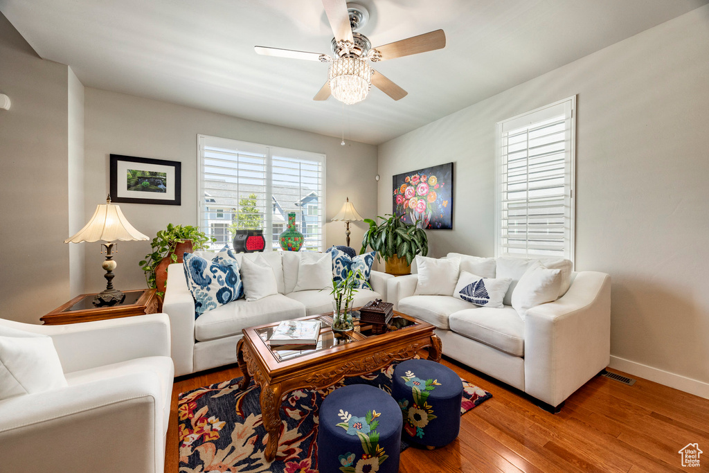 Living room with ceiling fan and wood finished floors
