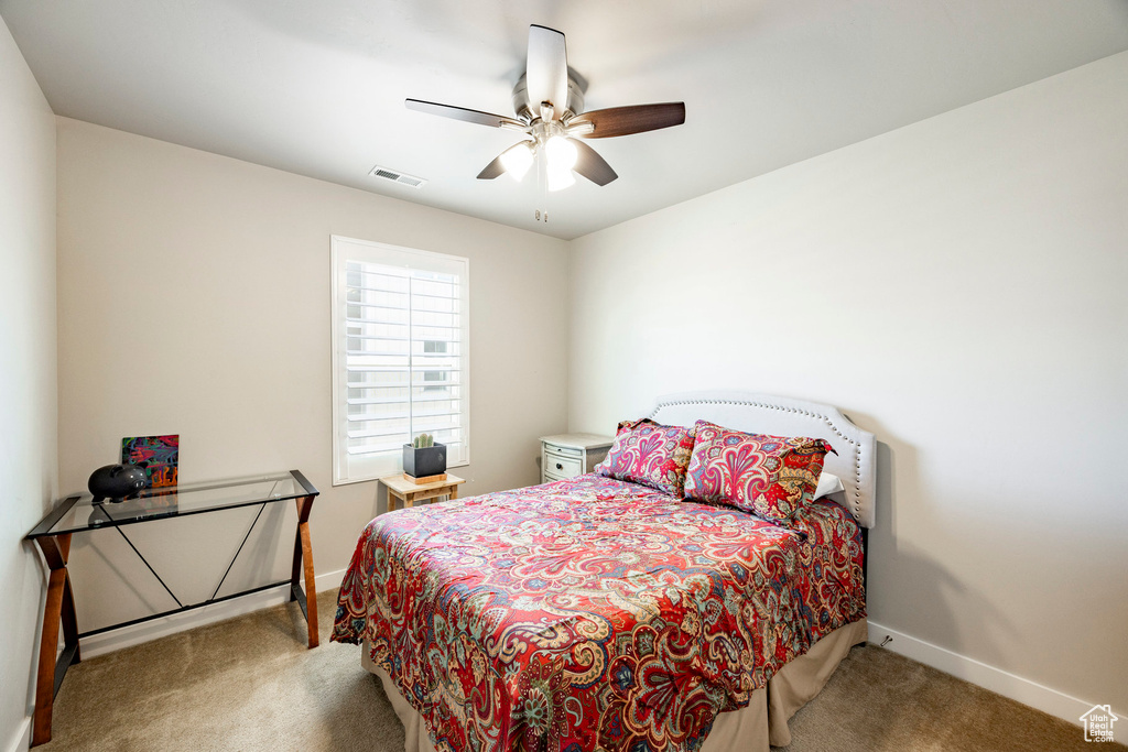 Bedroom featuring carpet and ceiling fan