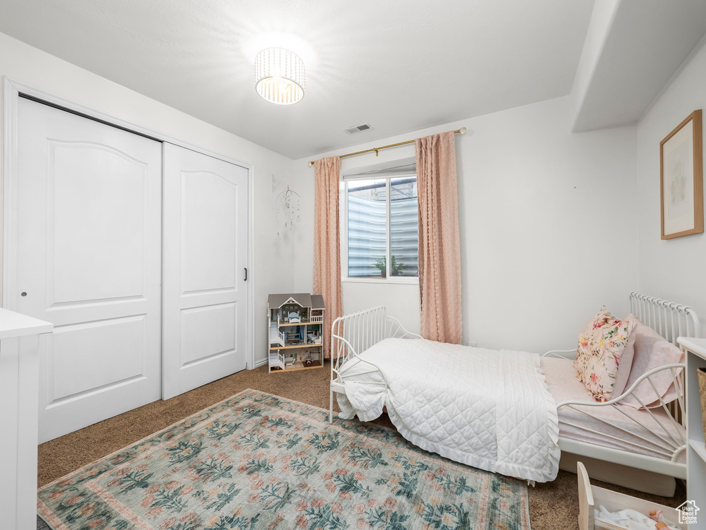 Bedroom with carpet and a closet