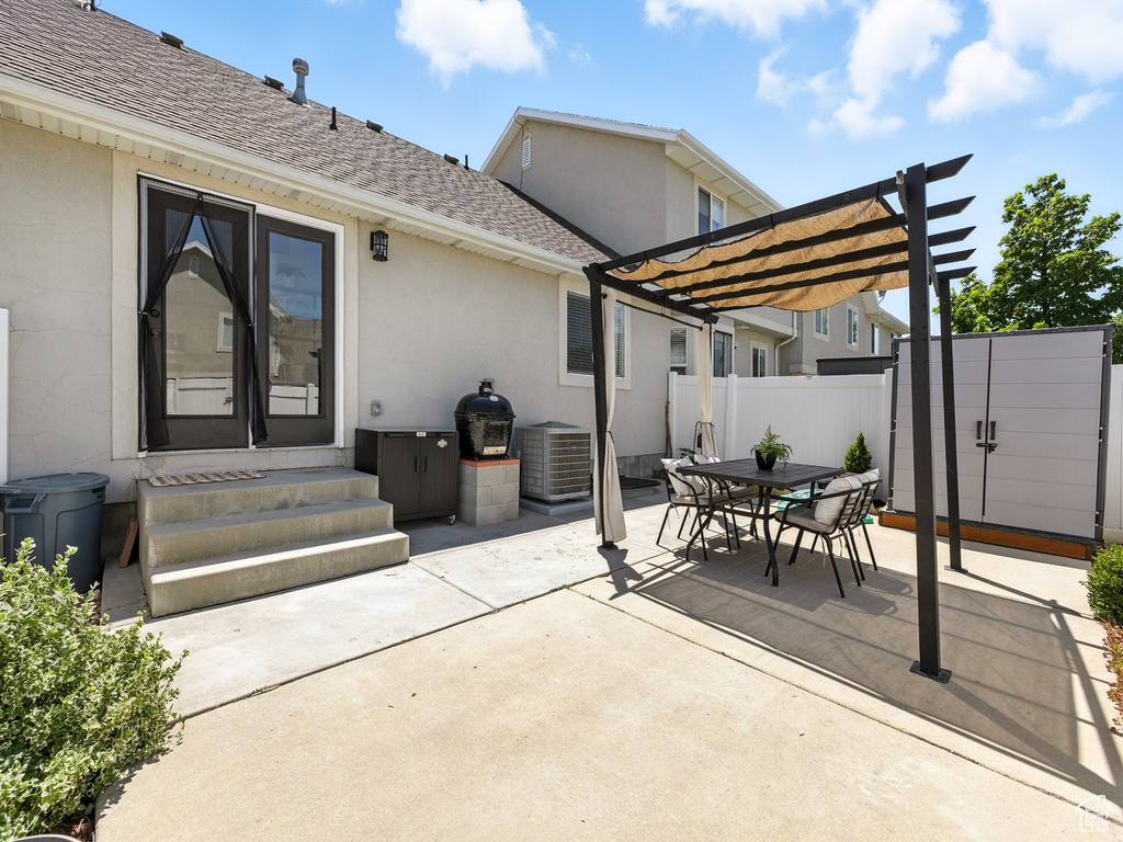 View of patio / terrace featuring a pergola, entry steps, and outdoor dining space