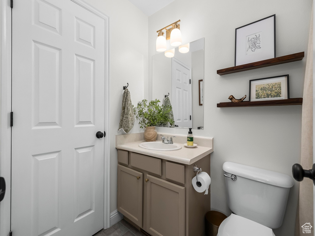 Half bath featuring vanity and toilet