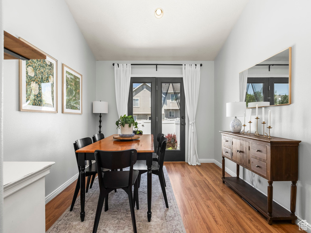 Dining room with light wood finished floors and french doors