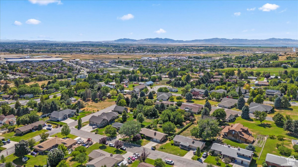 Aerial perspective of suburban area featuring a mountainous background