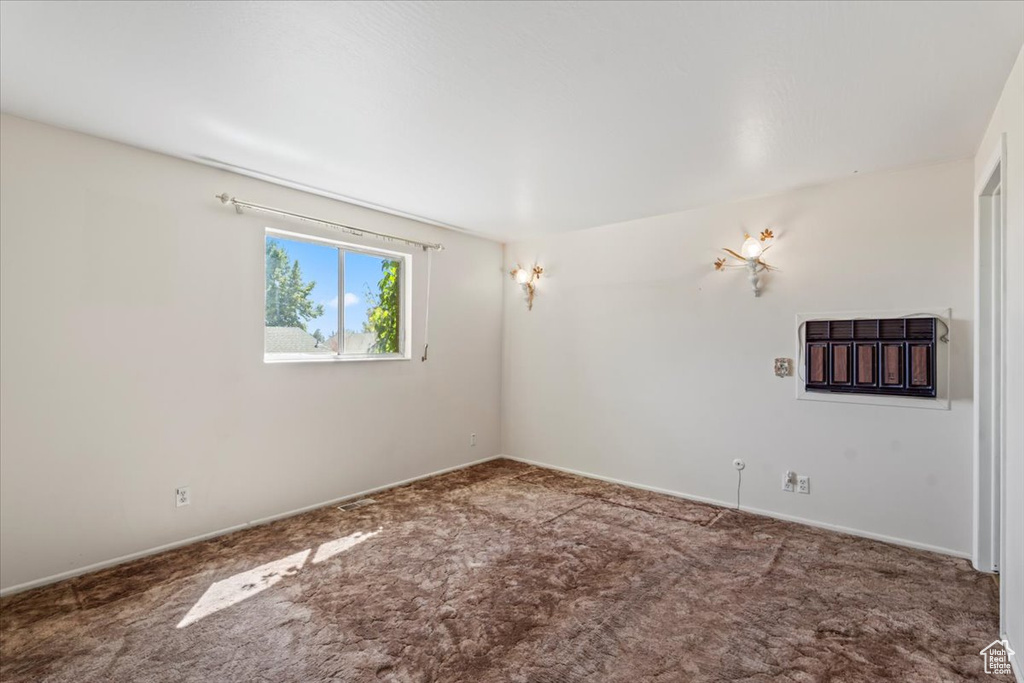 Unfurnished room featuring carpet floors and baseboards