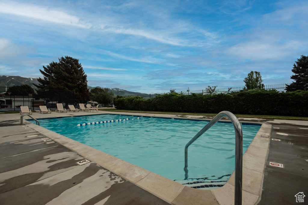 Community pool with a mountain view and a patio