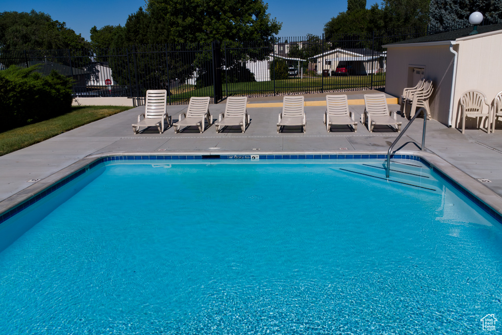 Community pool featuring a patio
