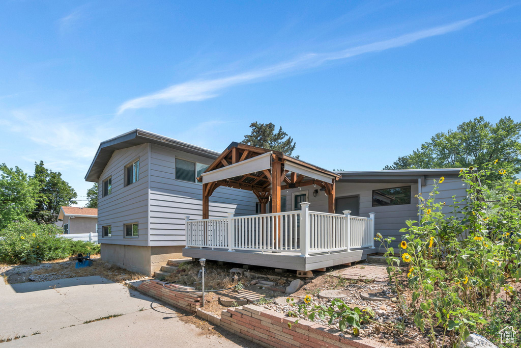 Rear view of property featuring a deck
