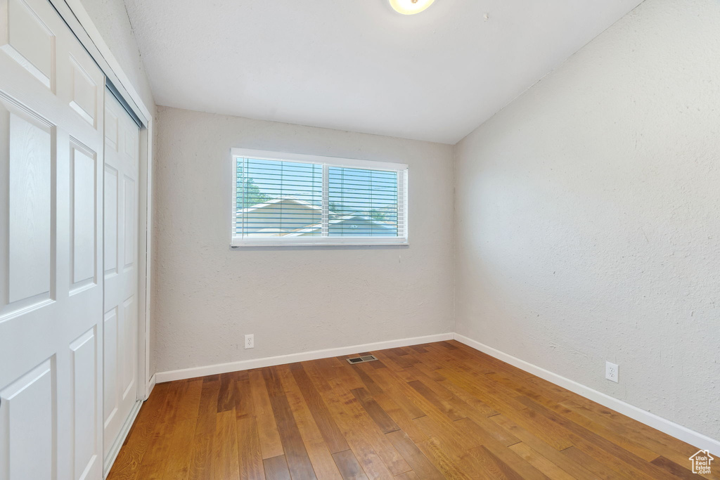 Unfurnished bedroom featuring a closet and wood finished floors