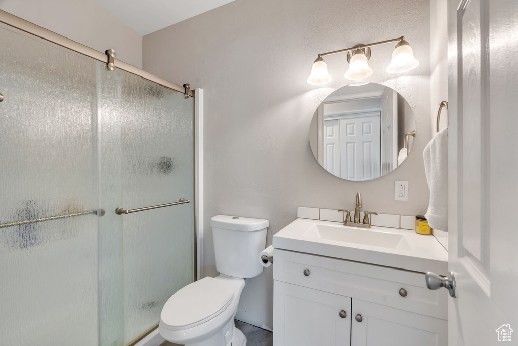 Bathroom featuring vanity and a shower stall