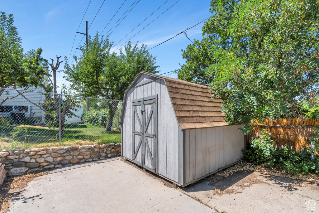 View of shed with a fenced backyard