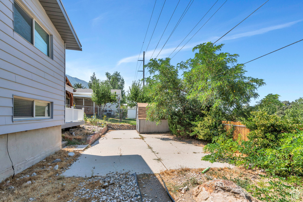 View of patio featuring a storage shed
