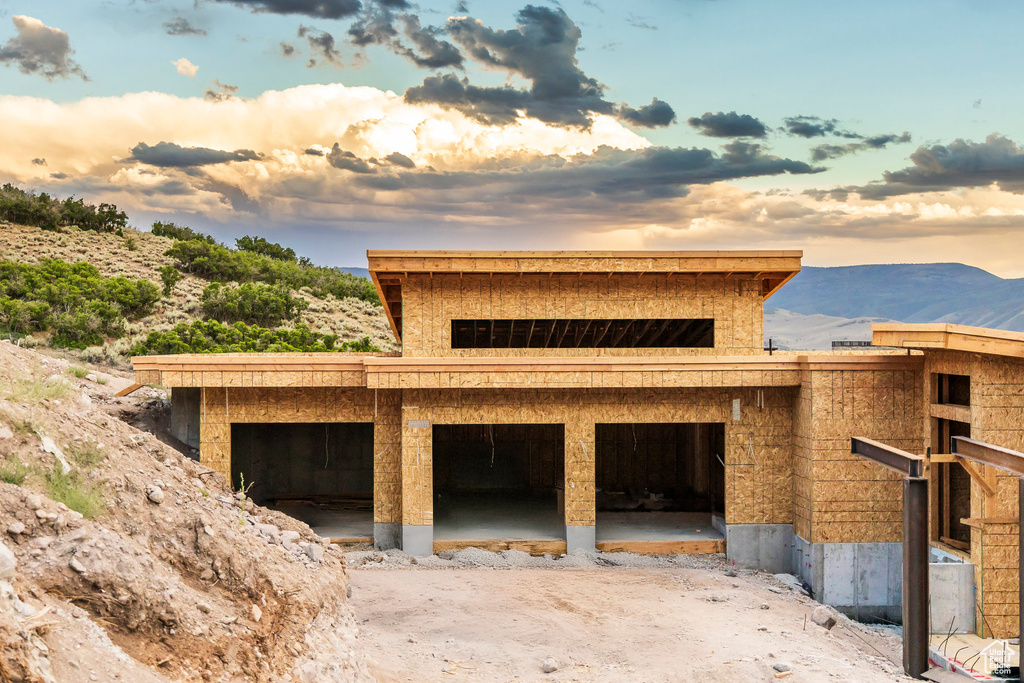 Garage at dusk featuring a mountain view