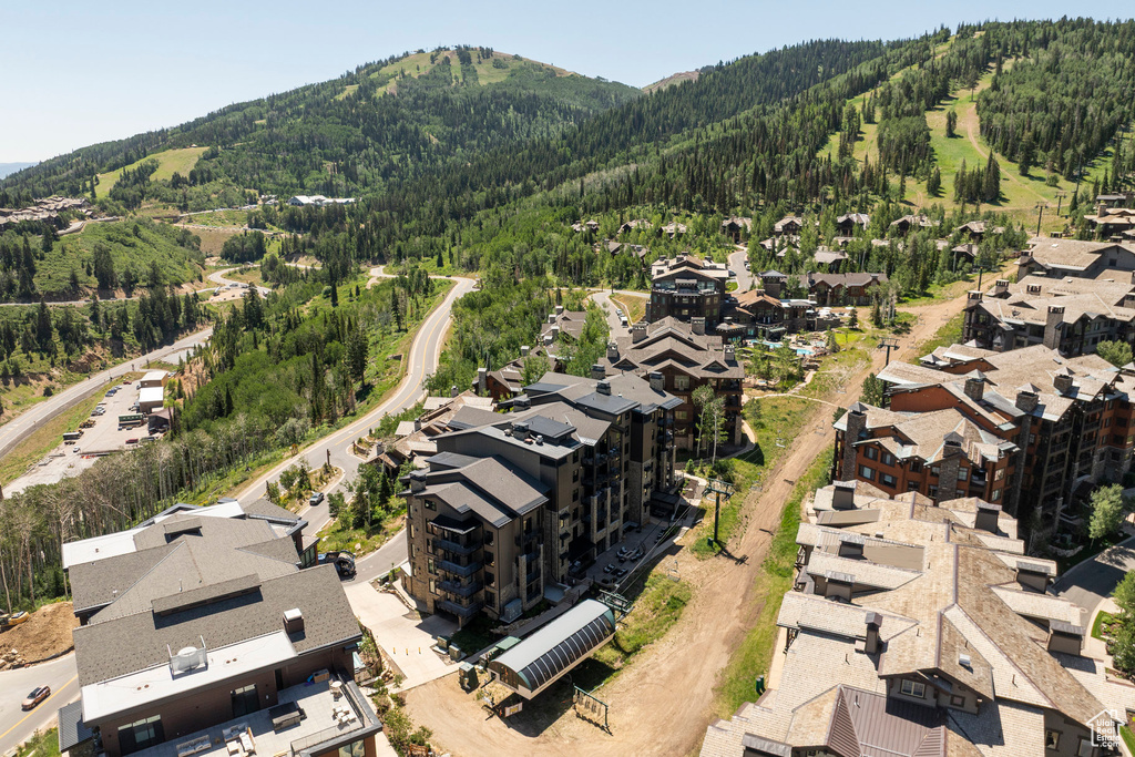 Aerial view of property and surrounding area with mountains and nearby suburban area