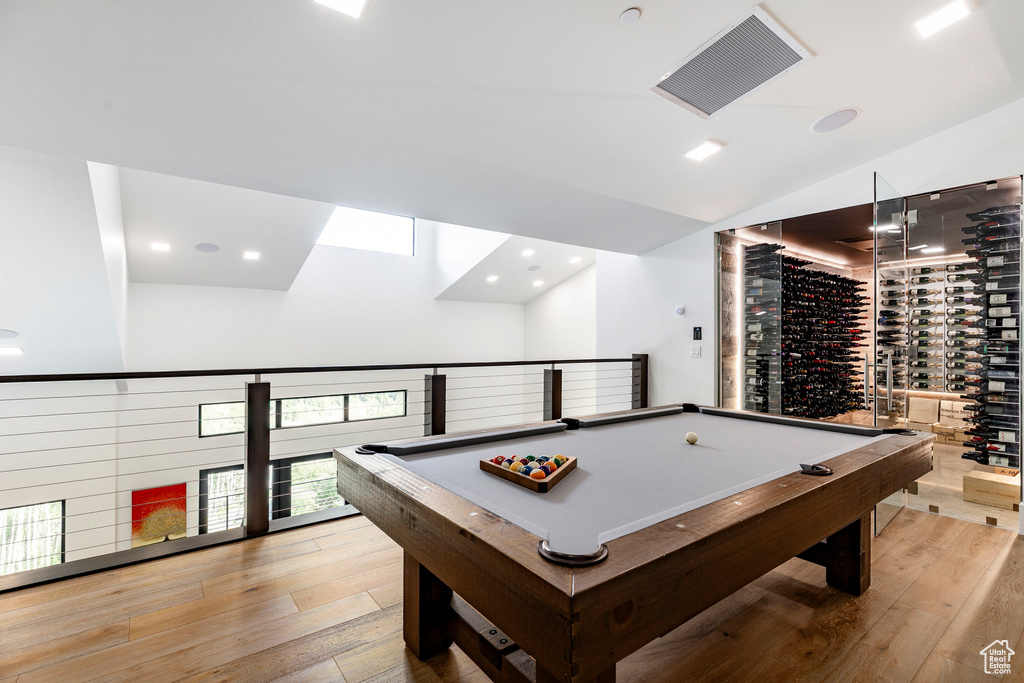 Recreation room with light wood finished floors, lofted ceiling, pool table, and recessed lighting