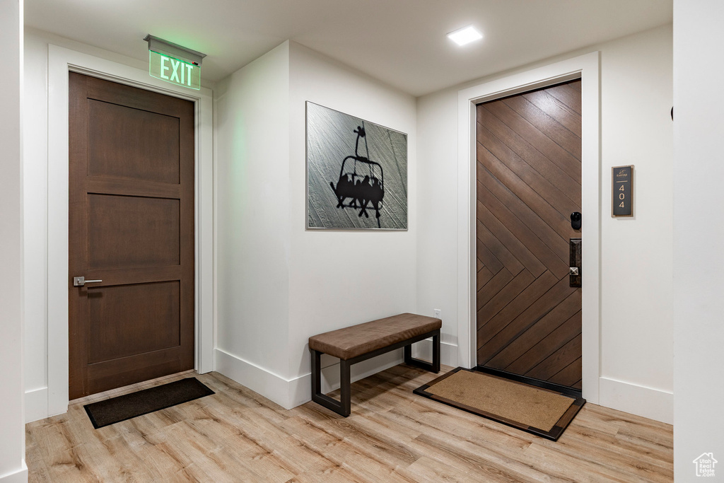 Foyer with light wood finished floors and baseboards