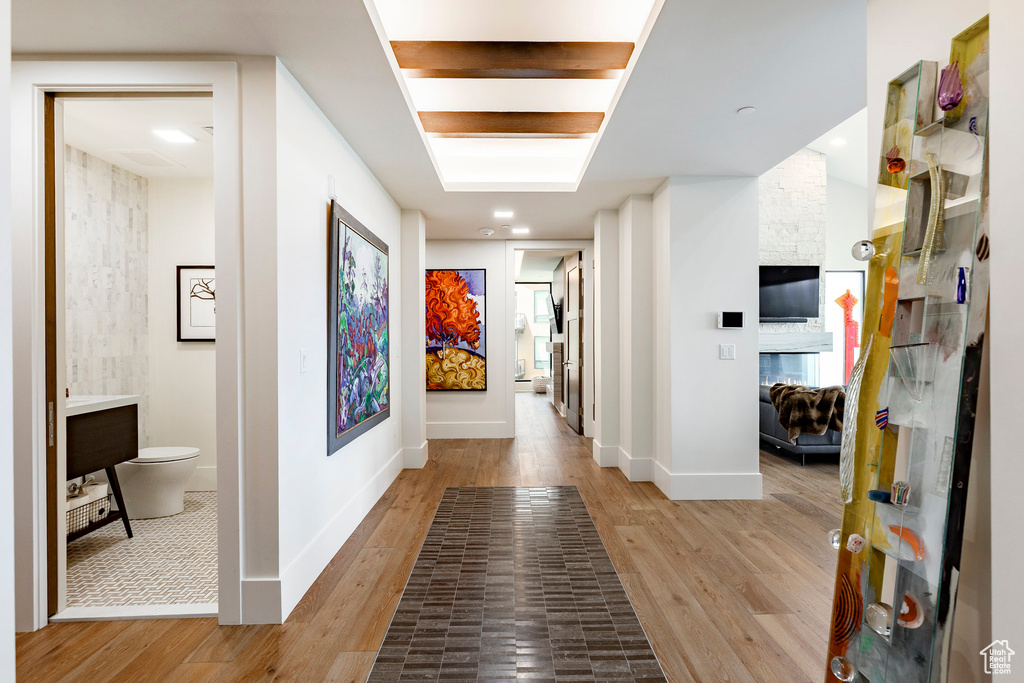 Hallway with light wood-style flooring and baseboards