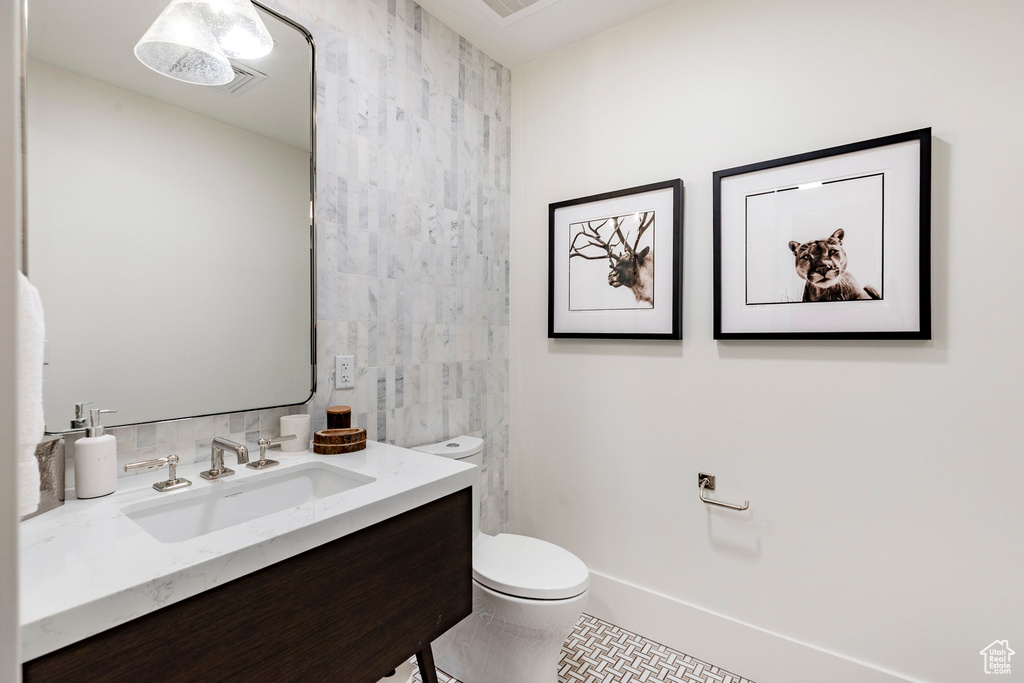 Bathroom with tile walls, vanity, and tile patterned floors