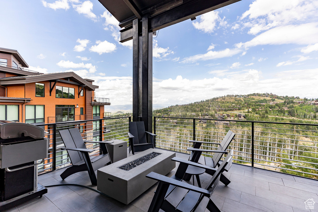 Patio / terrace with an outdoor fire pit and area for grilling