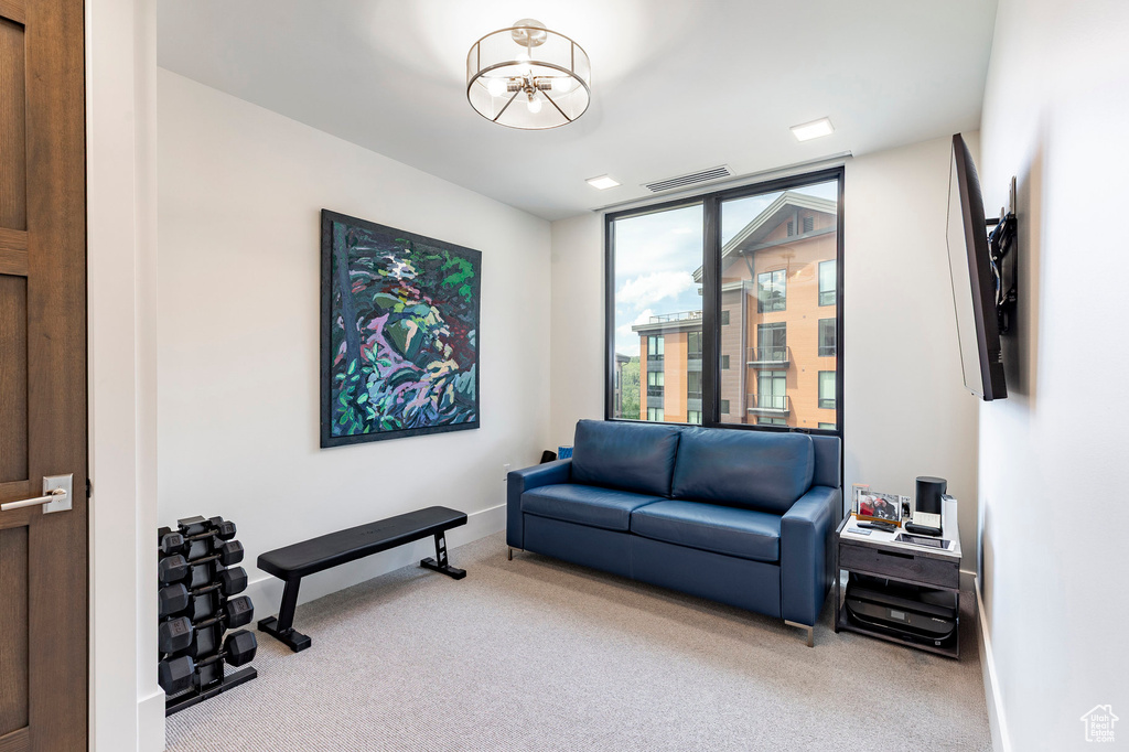 Living area featuring carpet floors and a chandelier