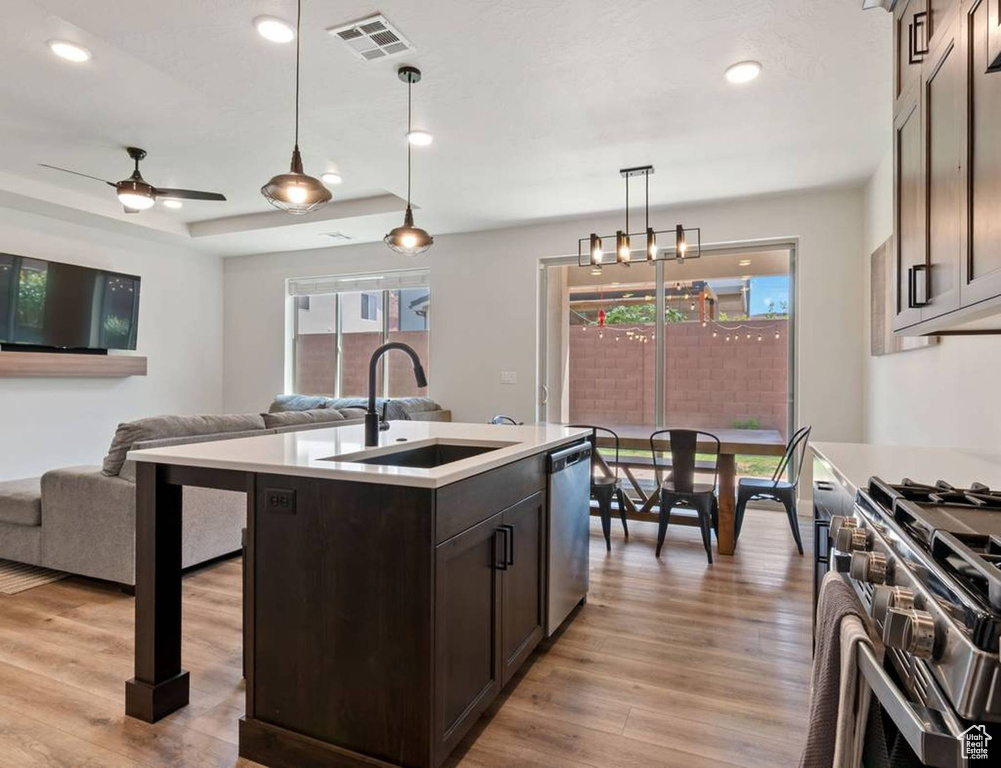 Kitchen featuring healthy amount of natural light, light countertops, light wood-type flooring, open floor plan, and recessed lighting