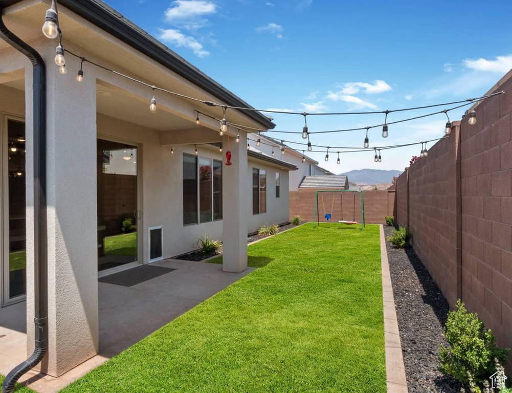 Fenced backyard with a patio area