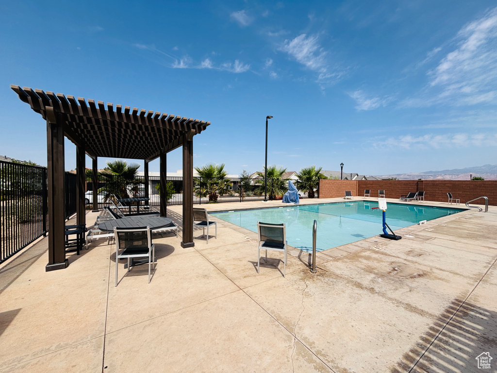 Community pool with a pergola and a patio