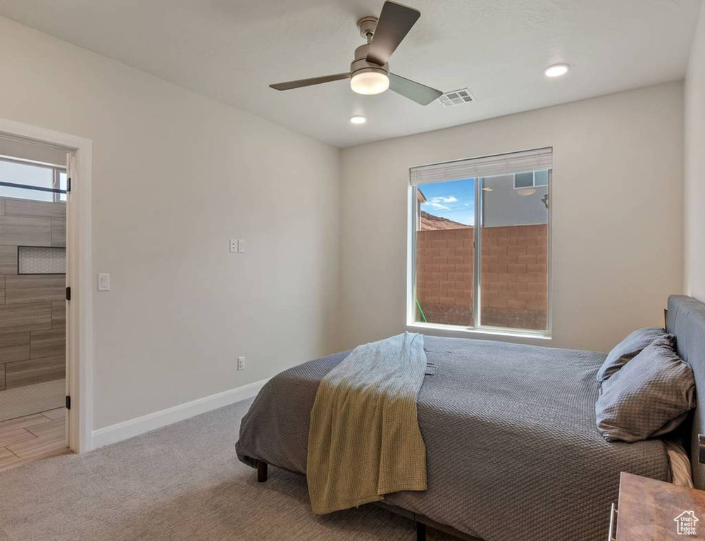 Carpeted bedroom with recessed lighting and a ceiling fan