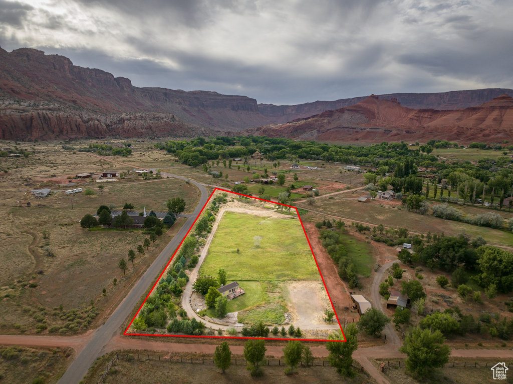Aerial view of sparsely populated area with mountains and property parcel outlined