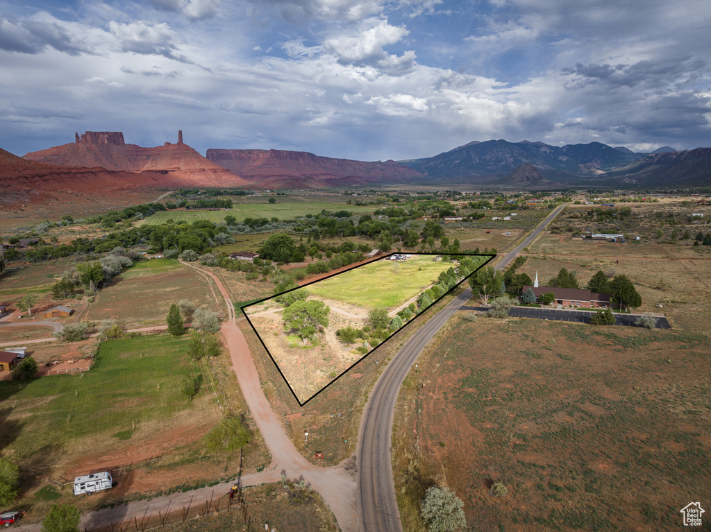 View of rural area featuring a mountain backdrop and property parcel outlined