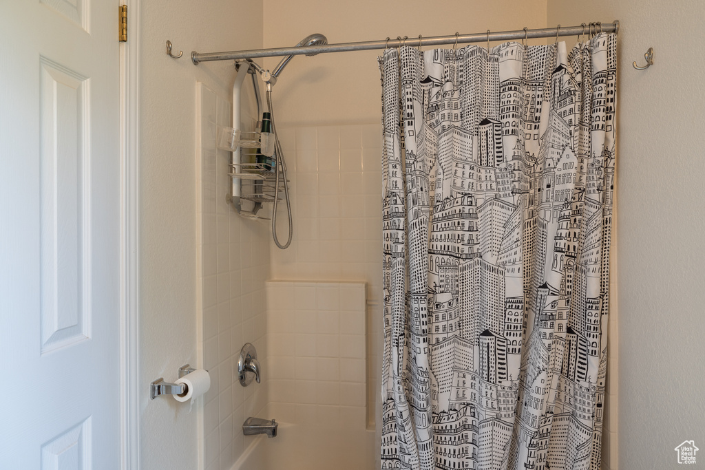 Bathroom featuring shower / tub combo with curtain