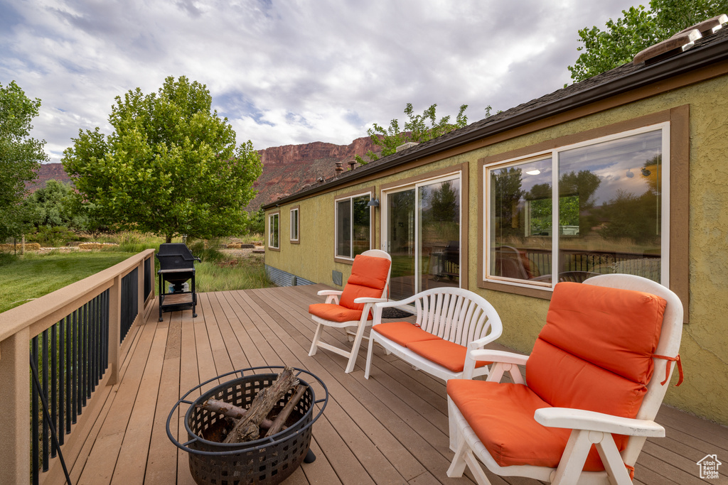 Deck with a mountain view and a grill
