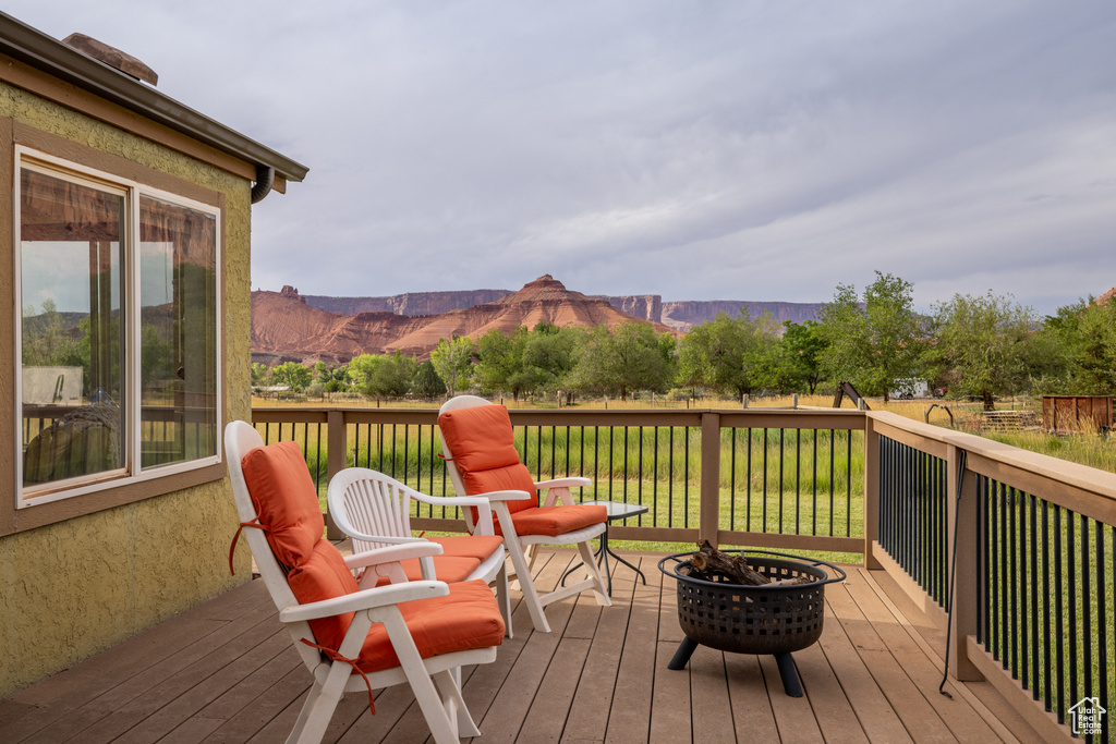 Deck with a mountain view and a fire pit