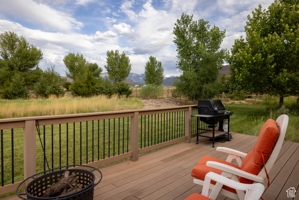 Deck featuring area for grilling, a yard, and a mountain view
