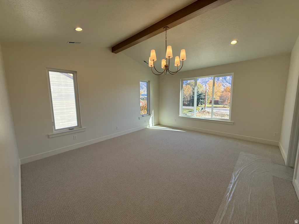 Unfurnished room featuring carpet, recessed lighting, a chandelier, healthy amount of natural light, and a textured ceiling
