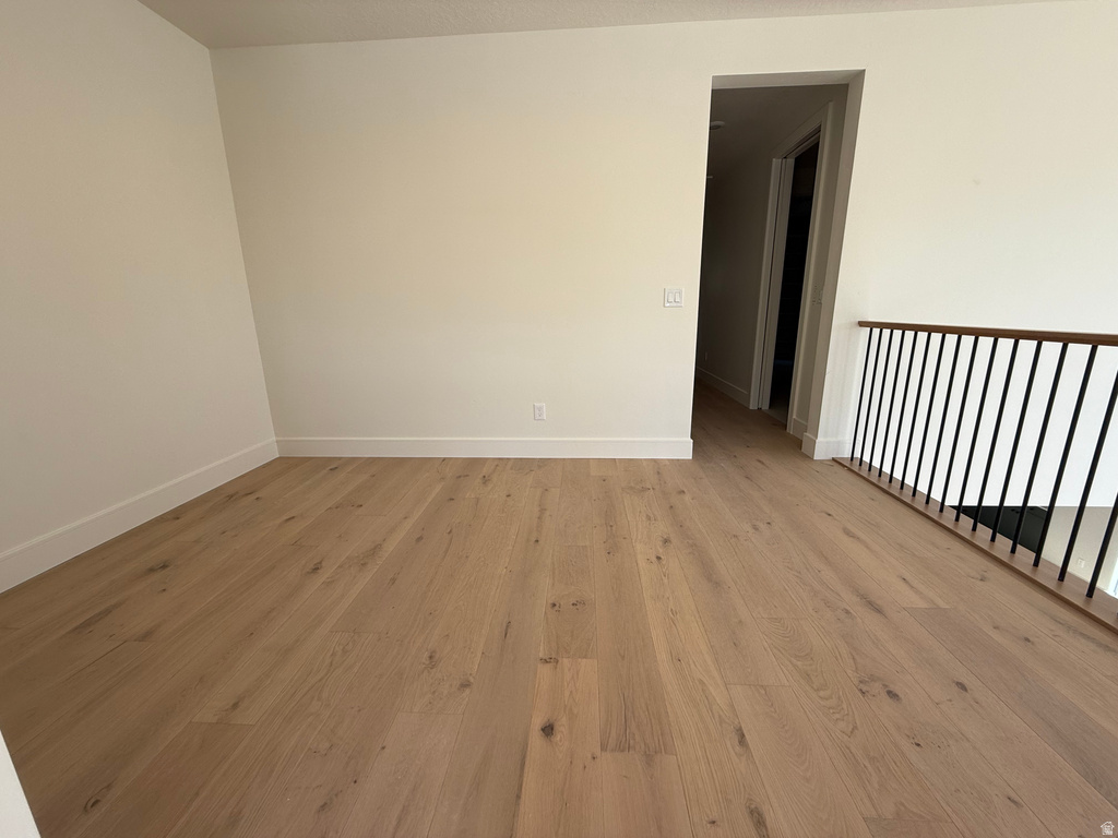Empty room with light wood finished floors
