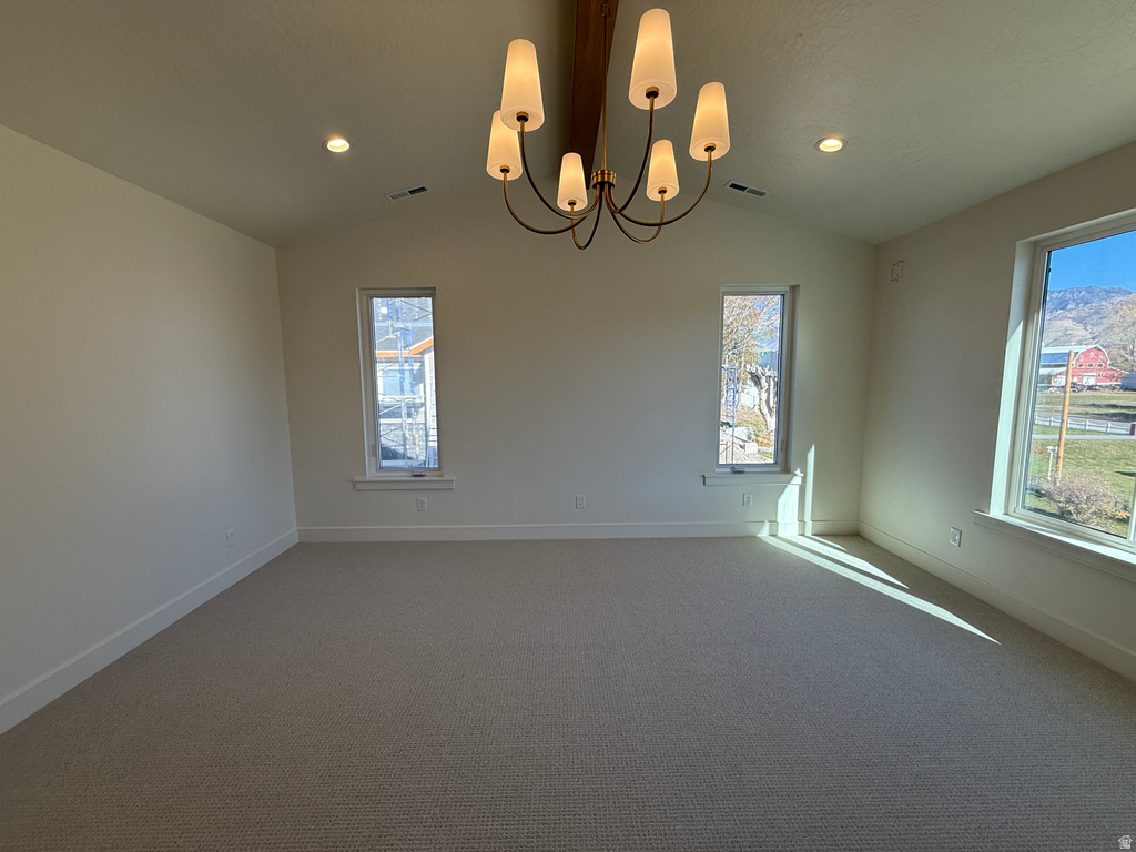 Unfurnished room with carpet, lofted ceiling, a chandelier, and recessed lighting