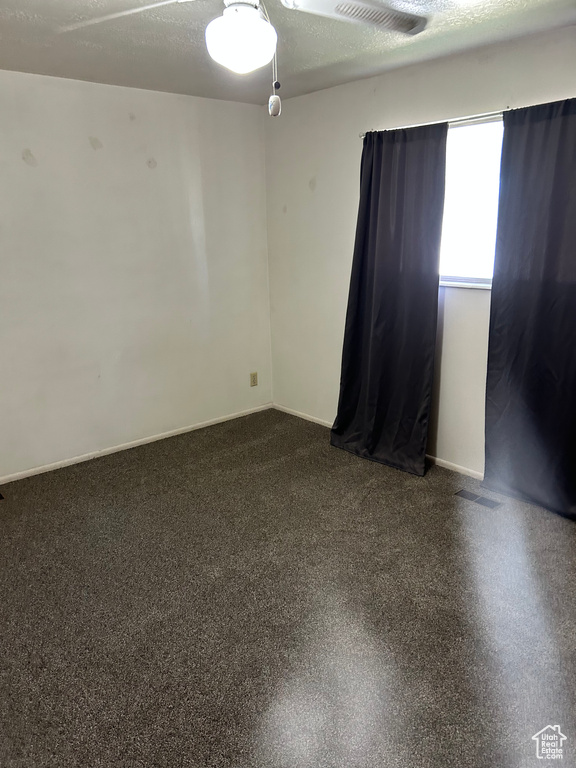 Spare room with ceiling fan