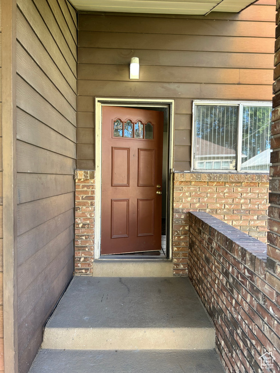 Entrance to property featuring brick siding