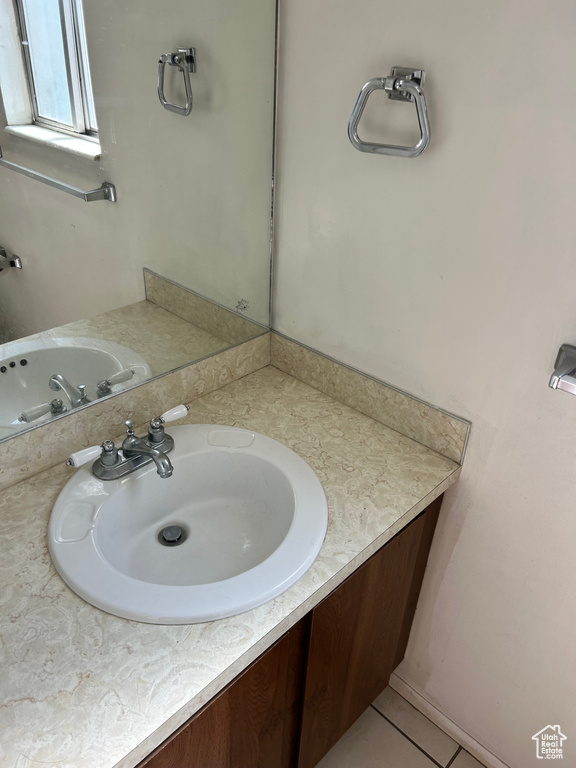 Bathroom with vanity and tile patterned floors